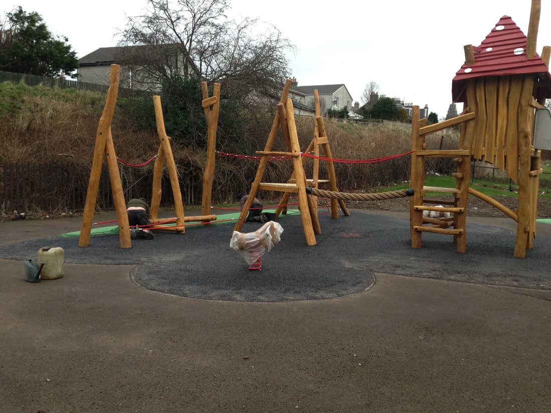 Installing artificial green grass on playground